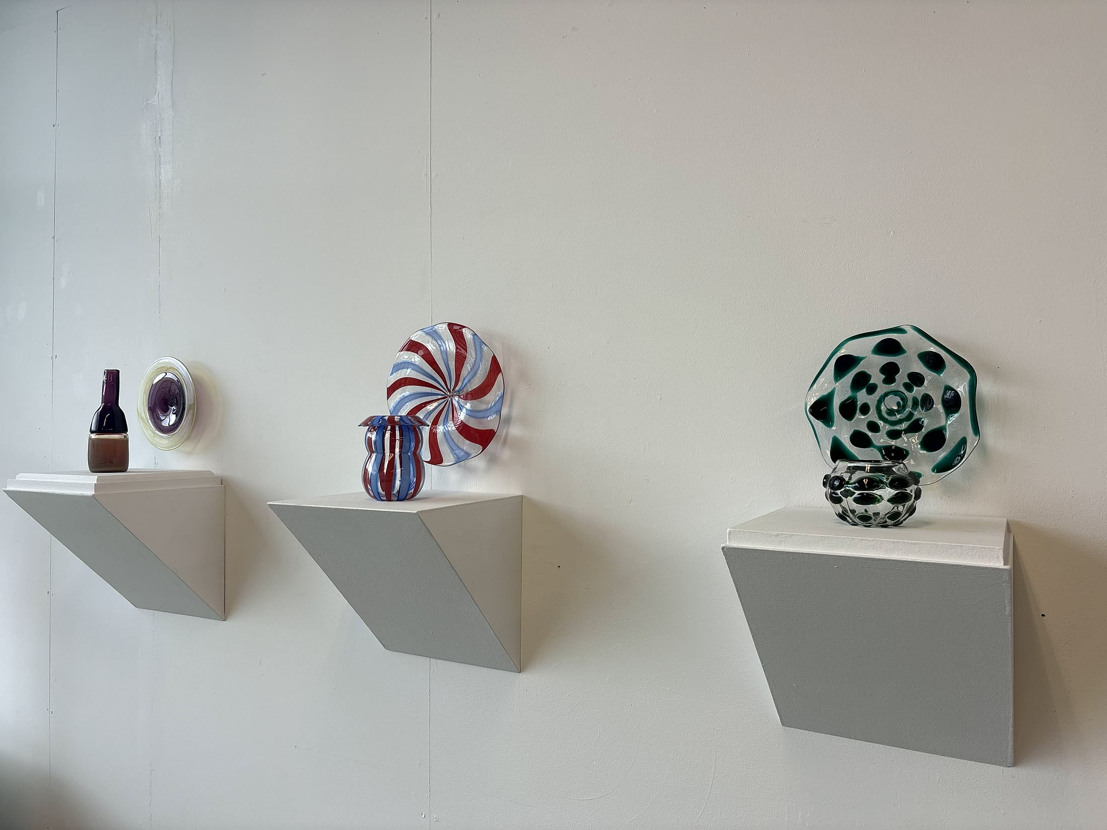 Gallery installation of colorful glass works